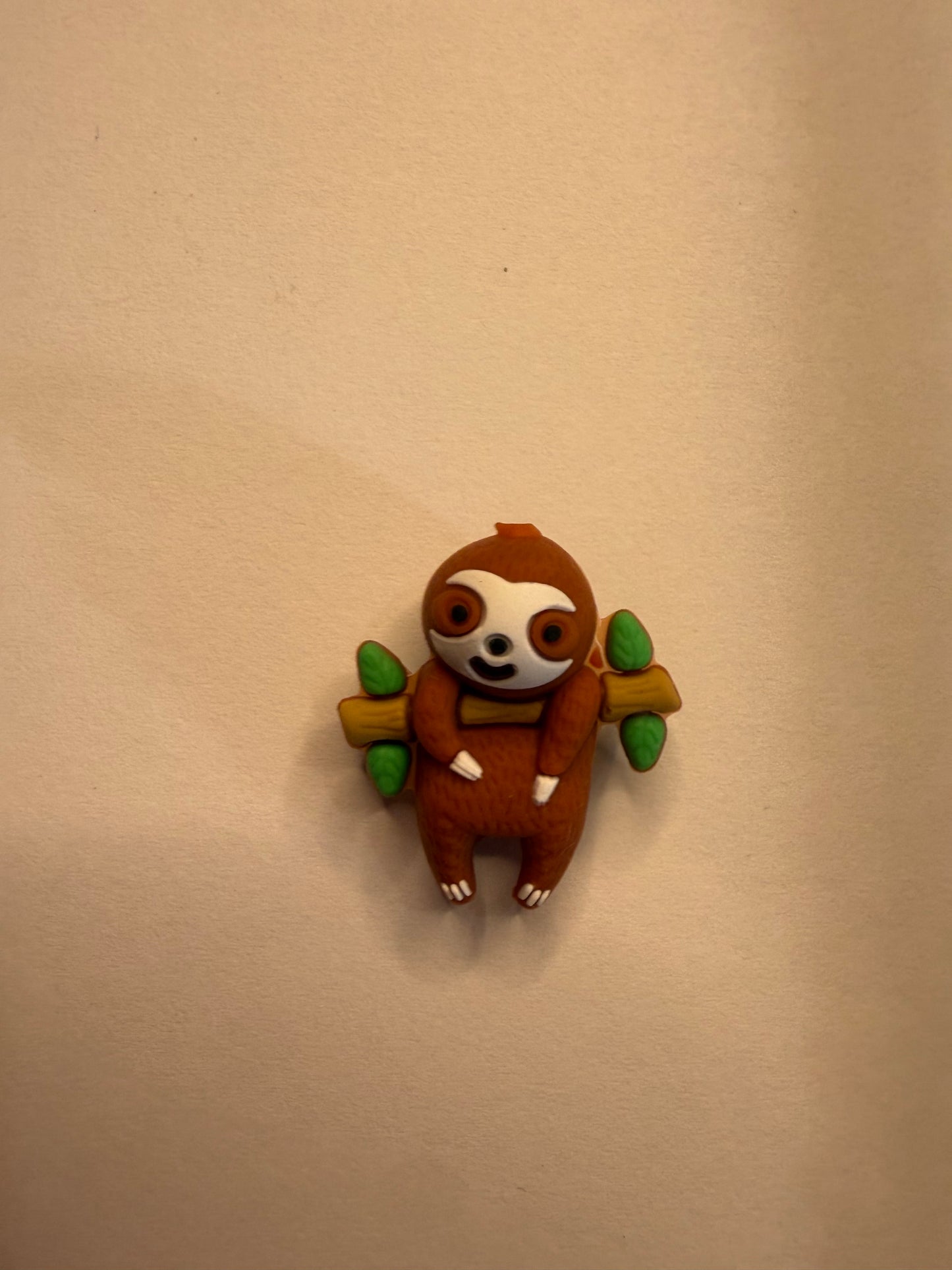 Focal 3d sloth hanging on branch